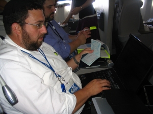 Avi Levine of Nefesh B'Nefesh processing passports during the flight
